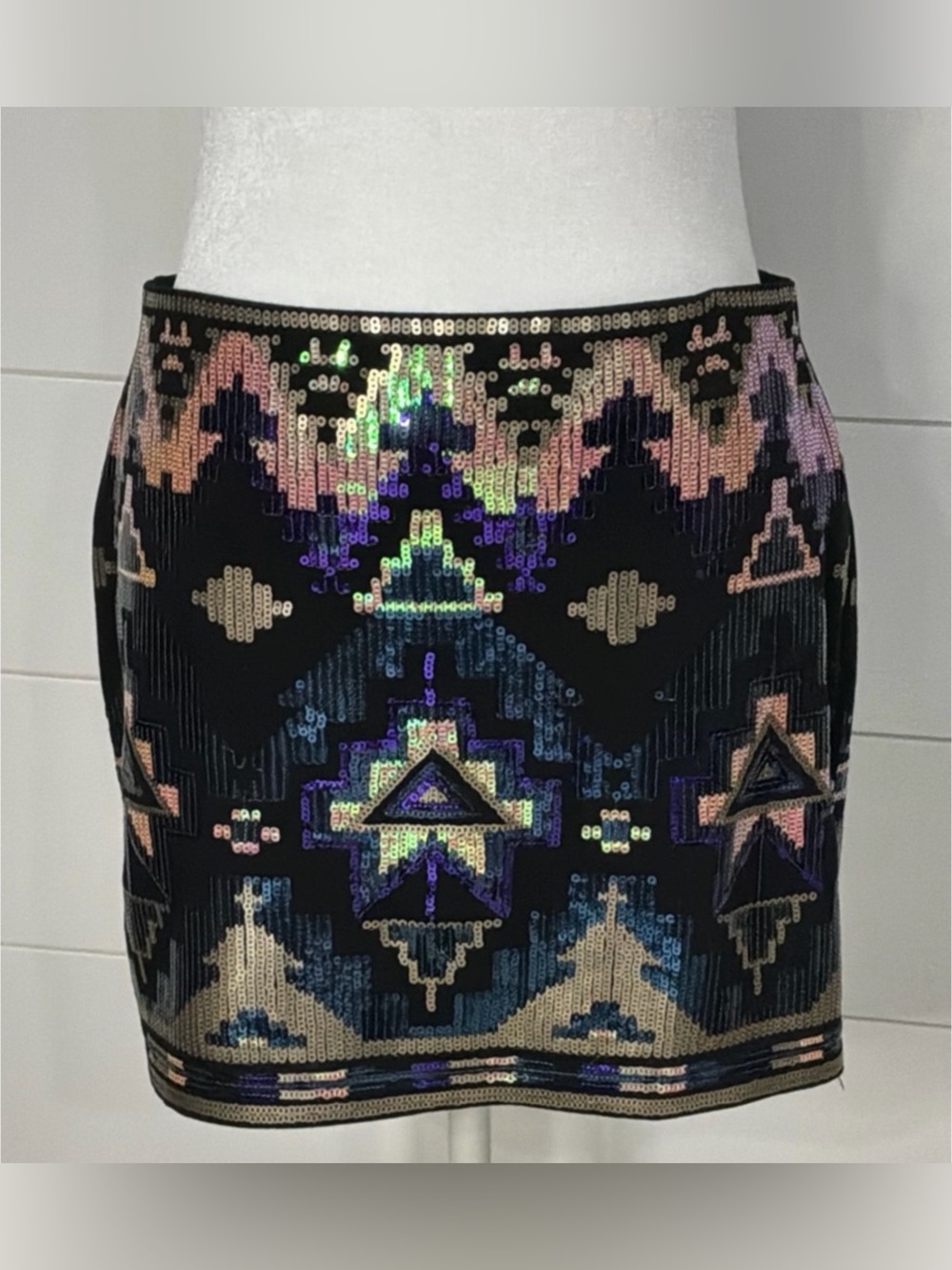 This Express mini skirt features a black base covered in a multicolor, iridescen